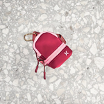 A small pink keychain bag with a secure zip closure and a clip for carrying.
