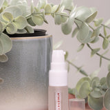 Skincare bottle with a plant in the background