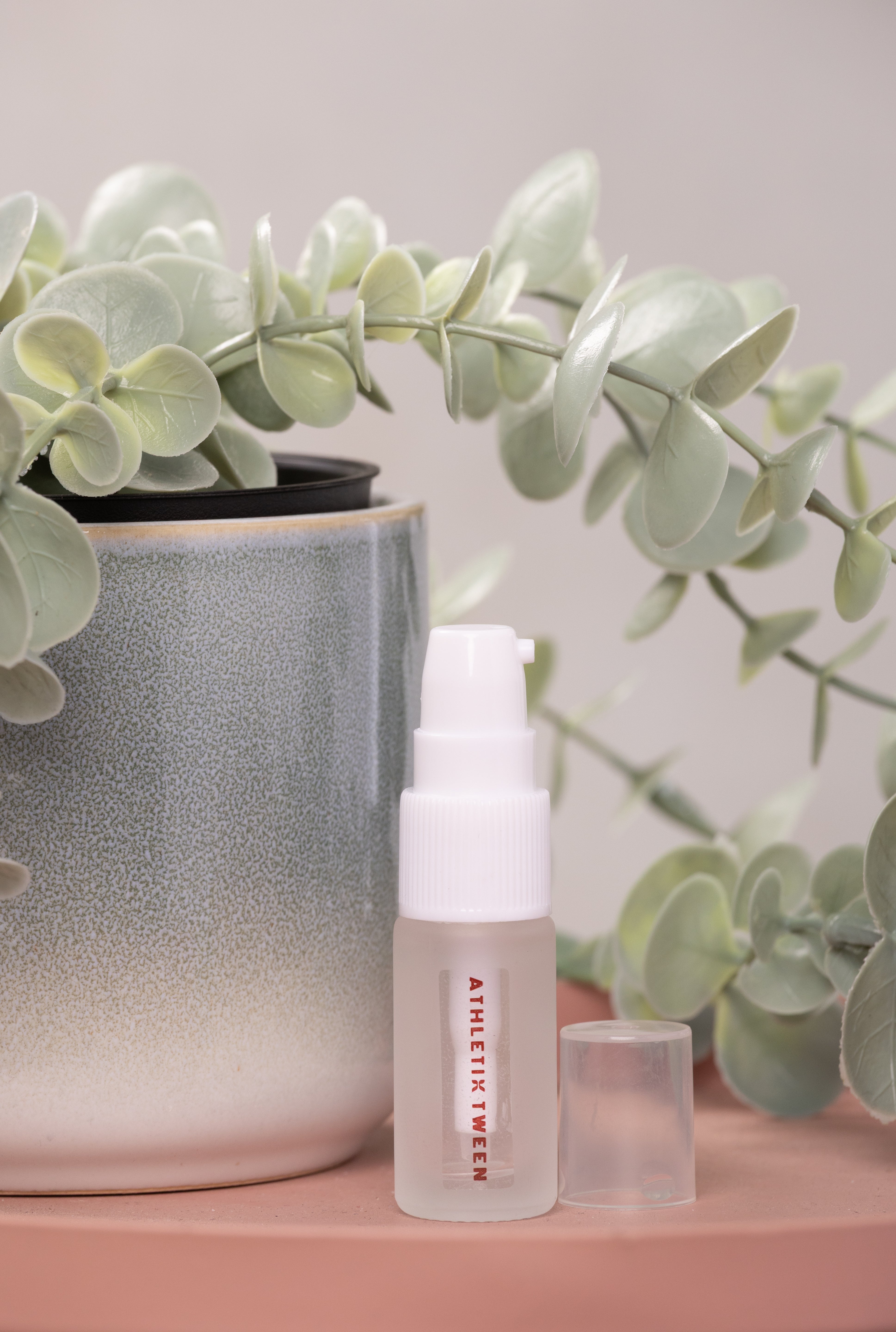 Skincare bottle with a plant in the background
