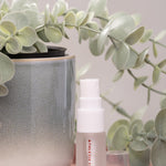 Skincare bottle with a plant in the background